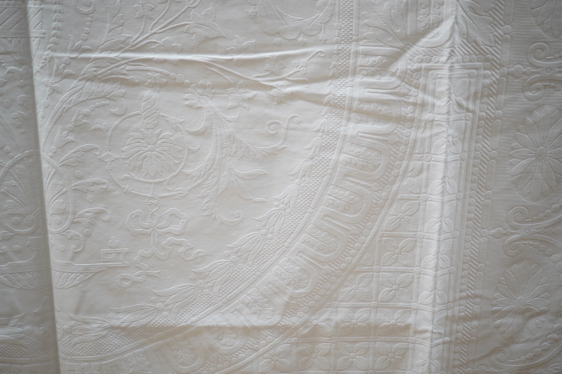 Three inspired Christopher Dresser white linen embossed bedcovers, with wide borders and ornate central designs, 216cm x 208cm. Condition - all good but will need rewashing.